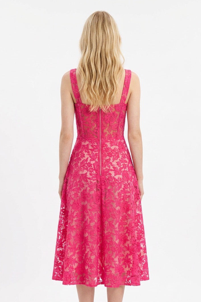 Woman wearing a pink lace dress on a white background
