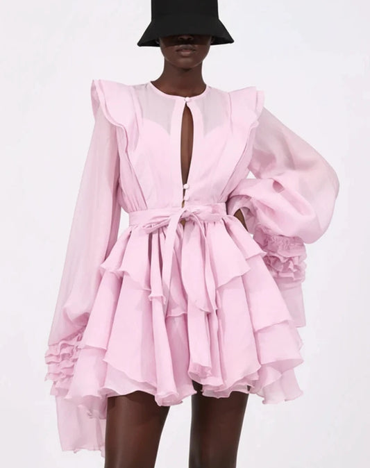 Black model in pink ruffle mini dress