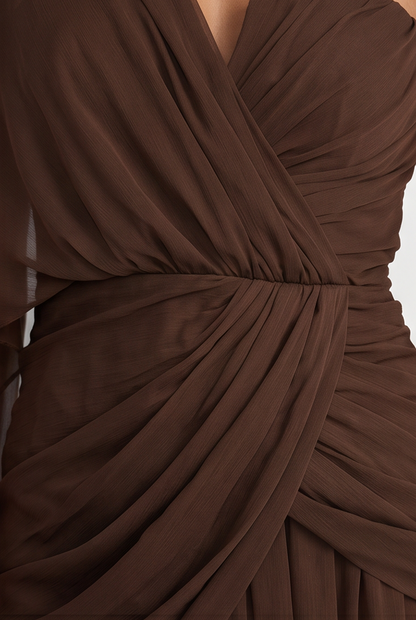 Brown dress with draped design on a neutral background
