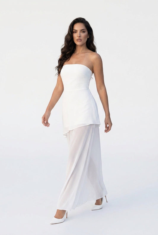 Woman wearing a white strapless dress on a white background
