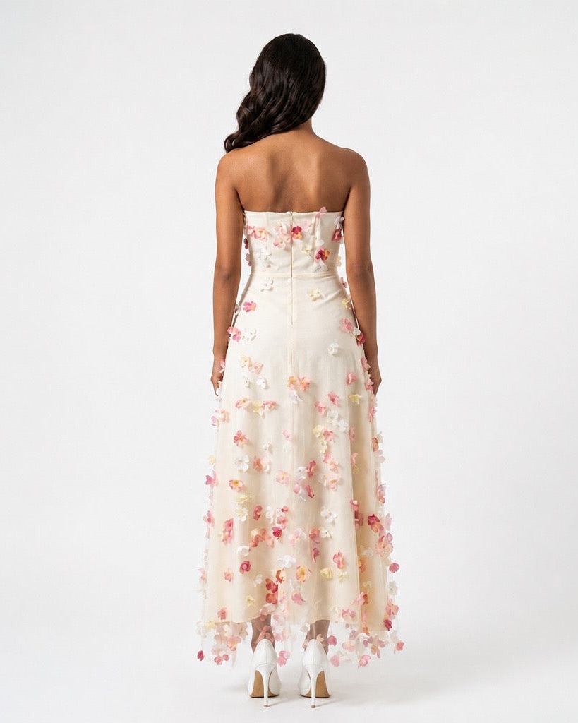 Woman wearing a strapless floral dress on a white background