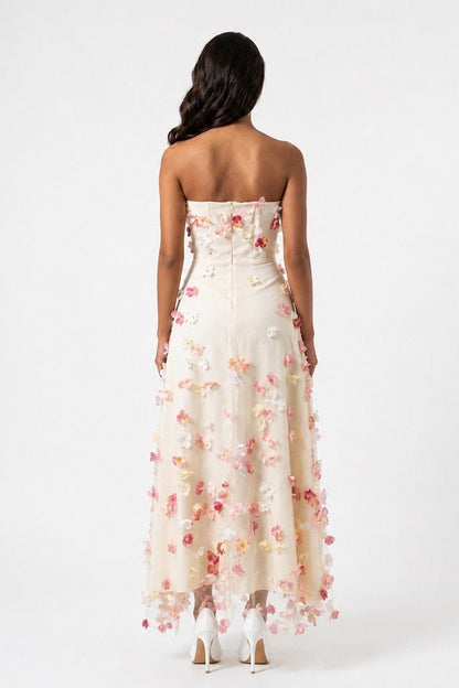 Woman wearing a strapless floral dress on a white background