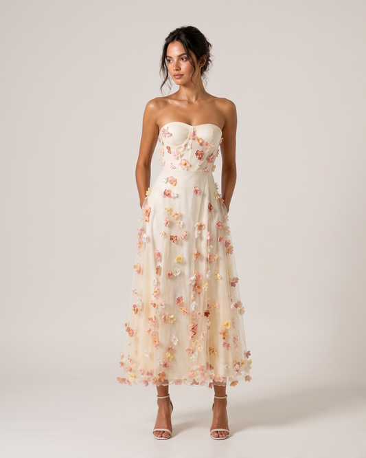 Woman wearing a strapless floral dress on a plain background