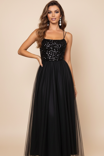 Woman wearing a black sequin dress with a beige background