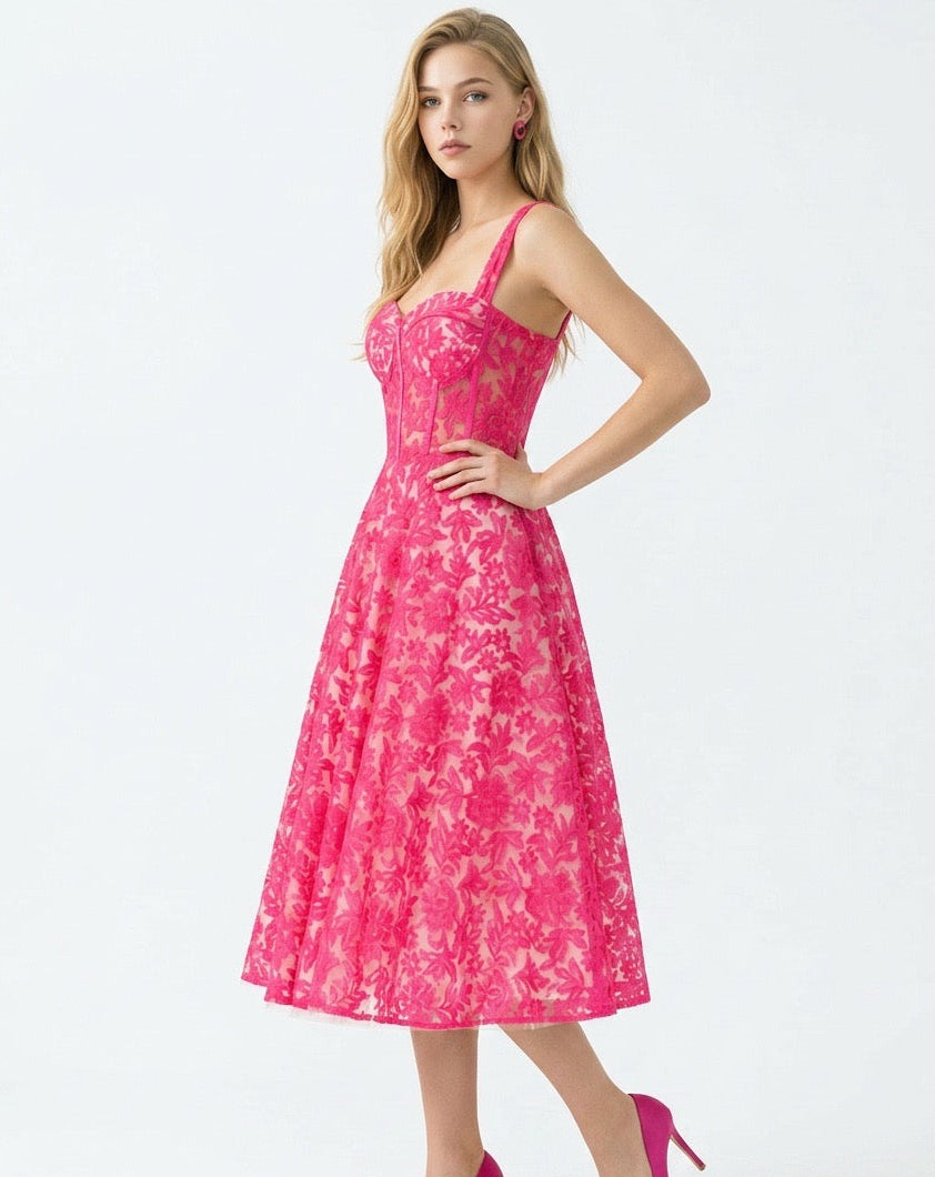 Woman wearing a pink floral dress on a white background