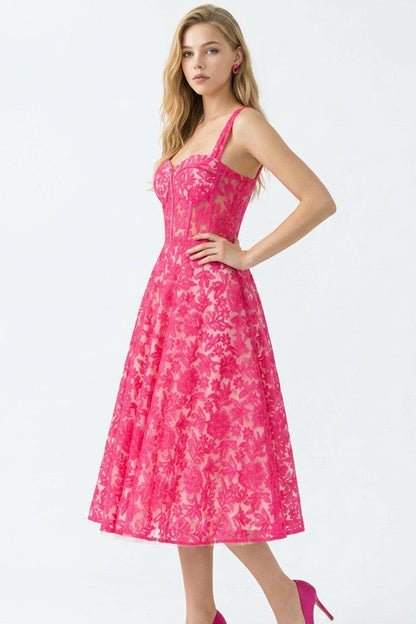 Woman wearing a pink floral dress on a white background