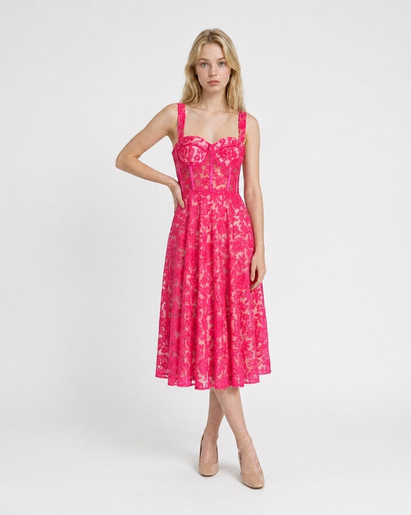 Woman wearing a pink floral dress on a white background