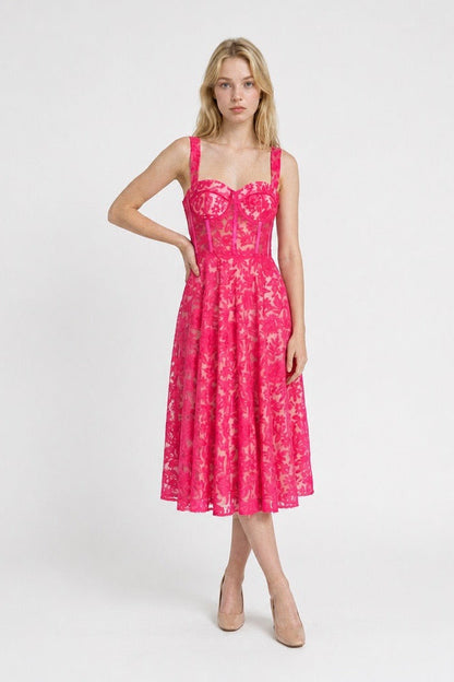 Woman wearing a pink floral dress on a white background