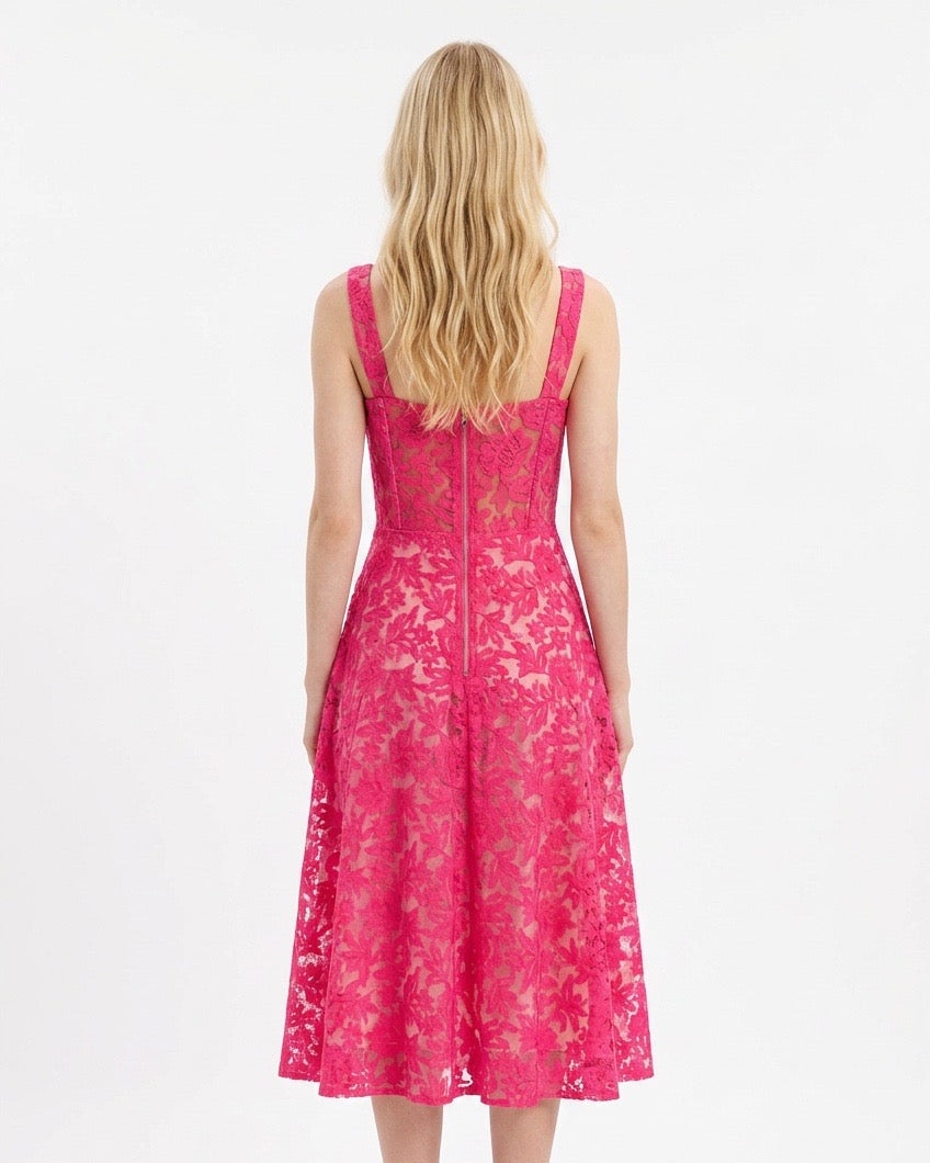 Woman wearing a pink lace dress on a white background