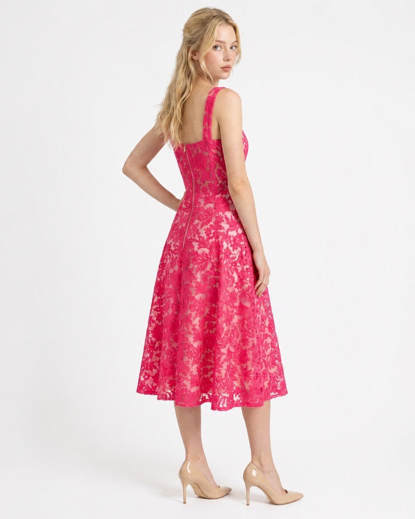 Woman wearing a pink floral dress on a white background