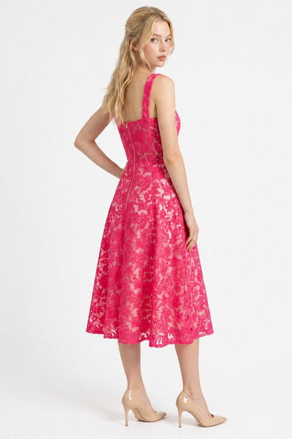 Woman wearing a pink floral dress on a white background