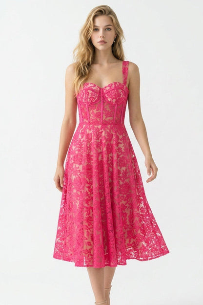 Woman wearing a pink lace dress on a white background
