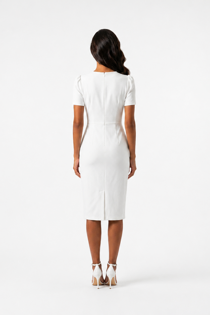 Woman wearing a white dress on a plain background